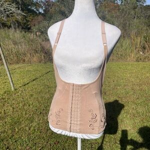 Corset body shaper in beige or nude with adjustable straps & hook/eye closure.